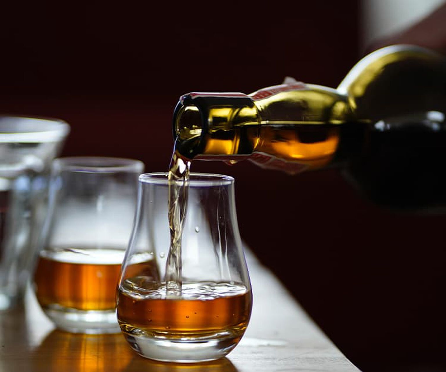 Bourbon being poured into two glasses